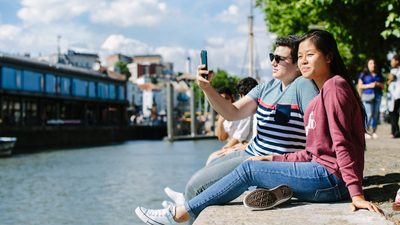 Students relaxing by the water in Bristol