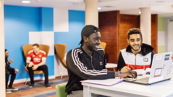 Students studying in the social area of the residence