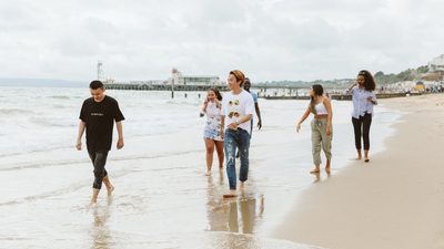 Students walking down the beach in Brighton