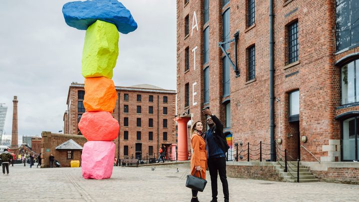 Students taking a selfie in a square in Liverpool