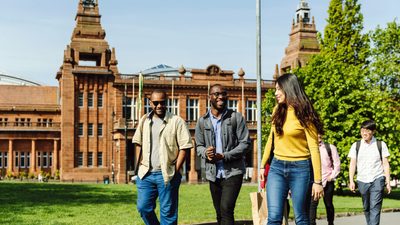 Students laughing and walking in Glasgow University campus