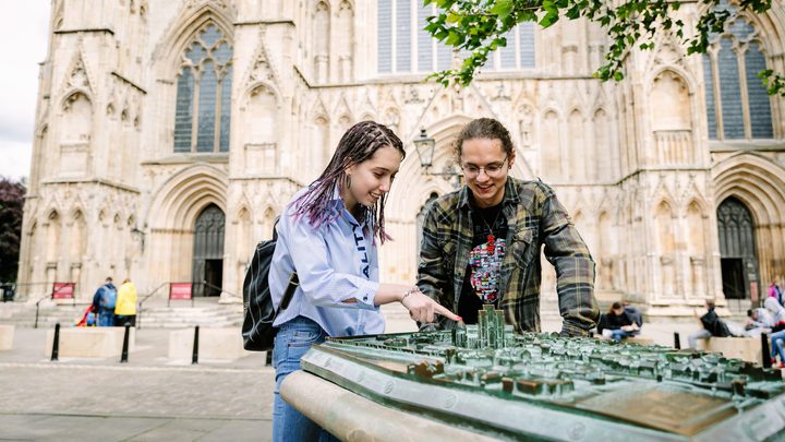 York students looking at a miniature of the city