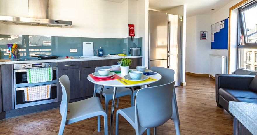 the shared kitchen with tables and chair at argyle street