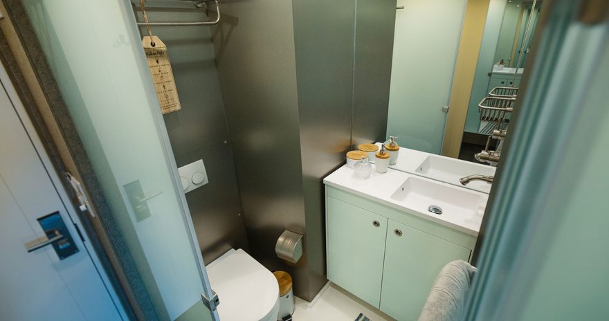 A look inside the bathroom with toilet and sink at the stay club