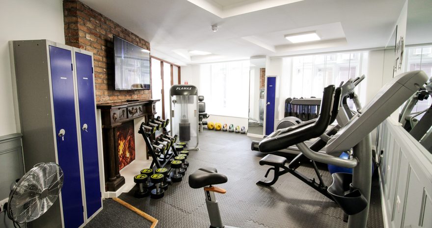 the gym machines and tv inside the gym room at Stanley House