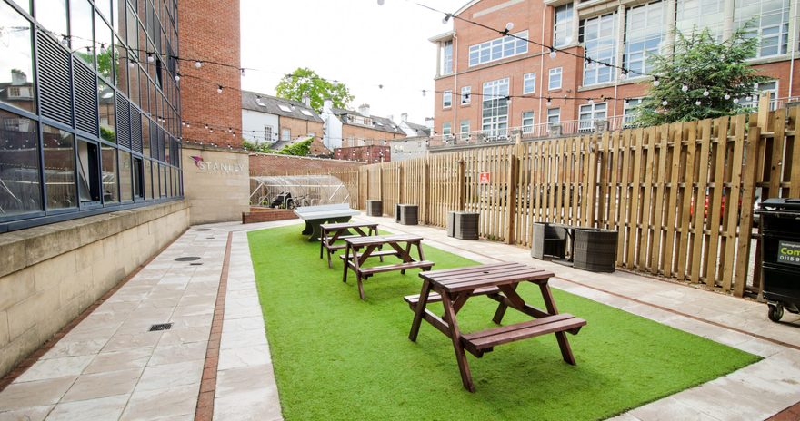 The outdoor area with picnic tables during the day at Stanley House