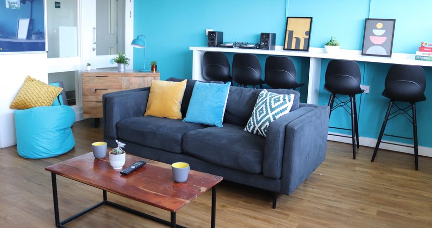 Living room with desks and a sofa