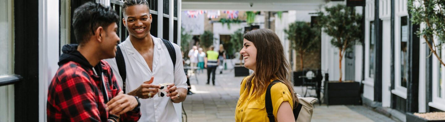 A group of students in Essex laughing on the street