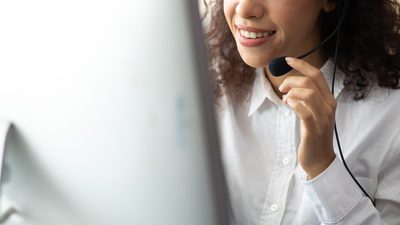 A receptionst smiling at the phone