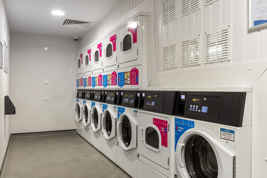 Washing machines in the laundry room inside Living Brighton accommodation