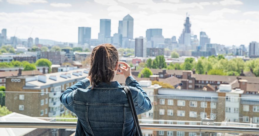 A girl taking a picture of the London skyline
