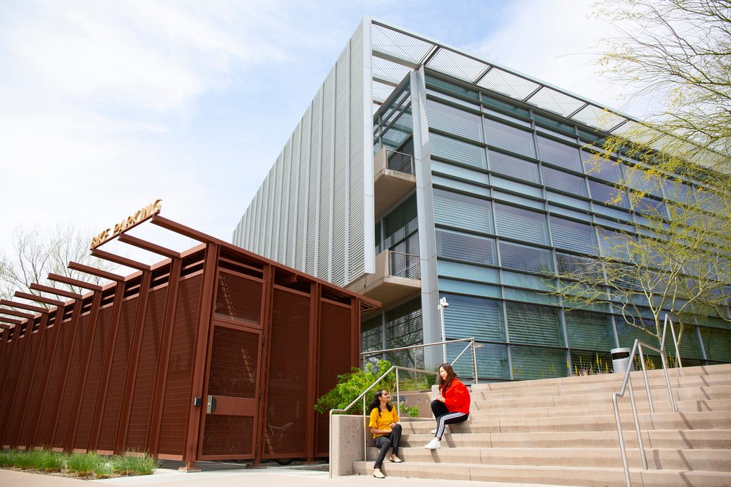 Two students sitting on the stairs of a ASU building