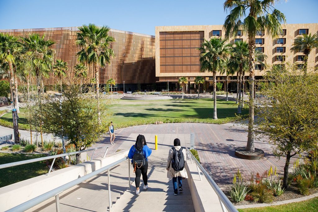 Two students walking down ASU's campus staircase