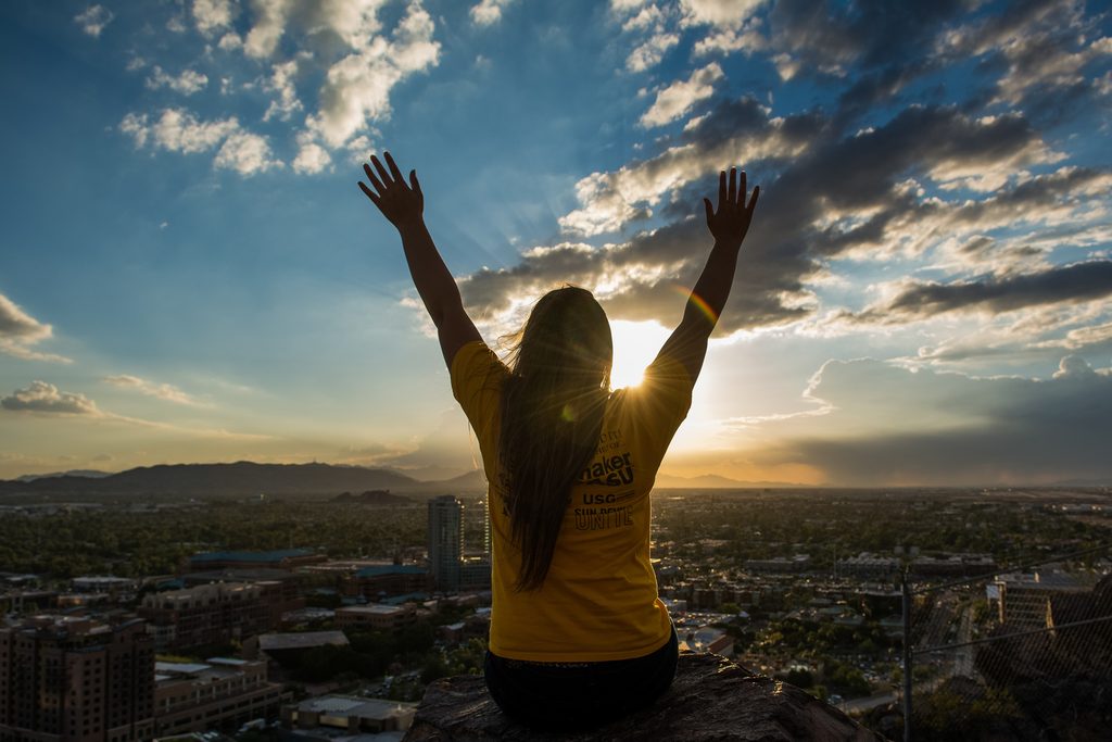A girl on top of a mountain