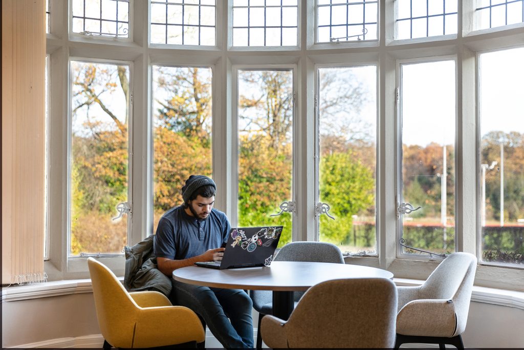 A student focusing on his laptop