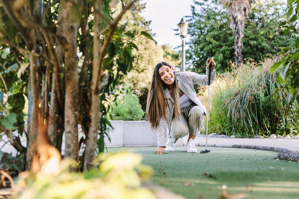 Student playing mini golf