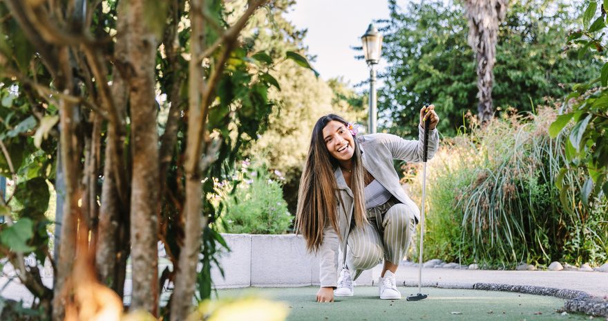 Student playing mini golf