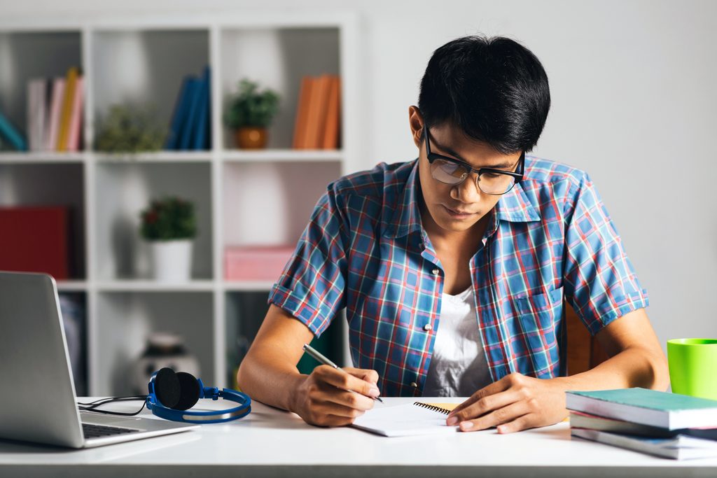 Student studying alone in his room