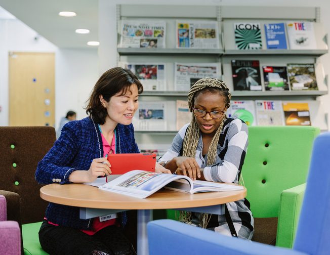 Student discussing with student services staff member