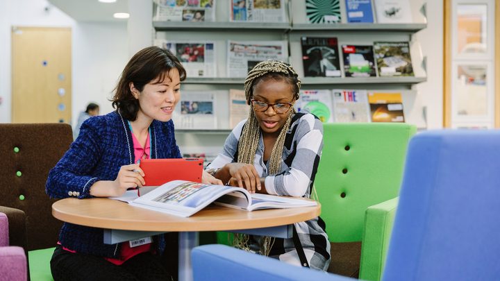 Student discussing with student services staff member