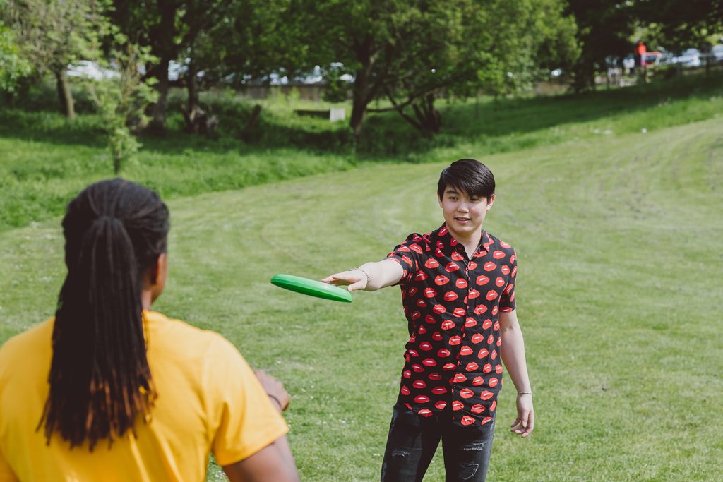 Students having fun playing frisbee together