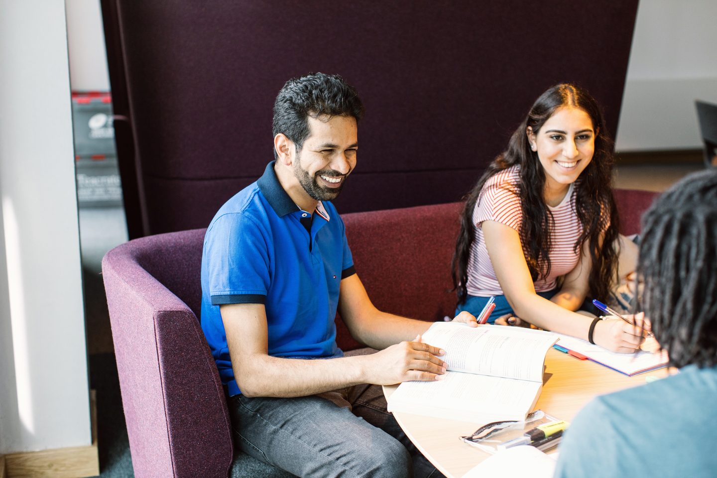 Students talking and studying at a roundtable