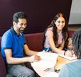 Students talking and studying at a roundtable