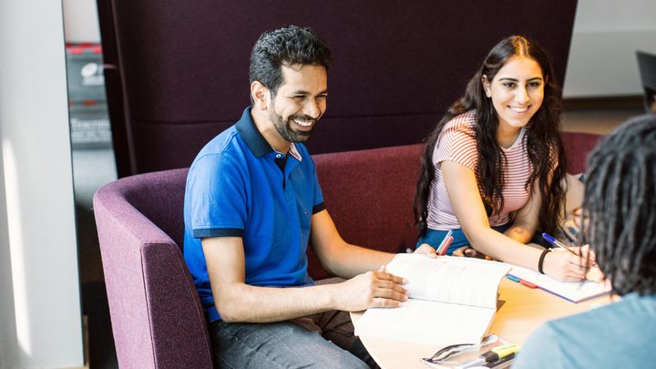 Students talking and studying at a roundtable