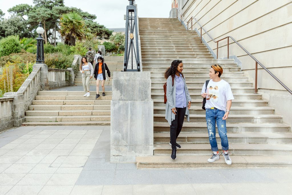 Students talking next to steps