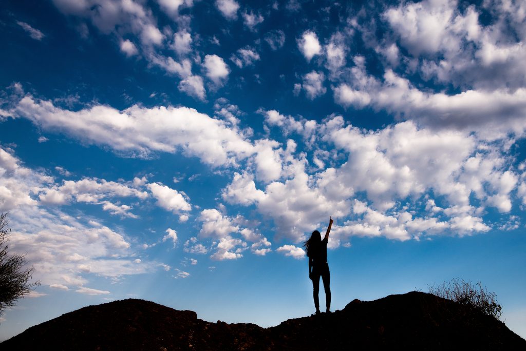 An ASU student pointing at the sky