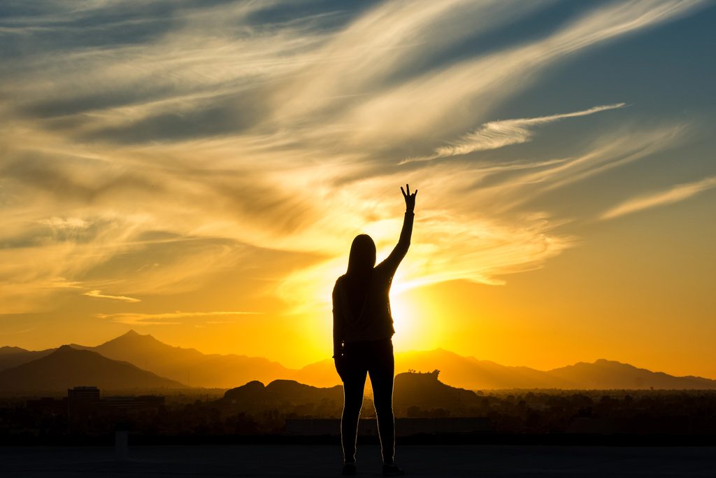 student watching sunset