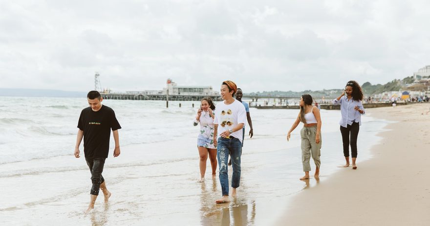 A group of six students walking on the bench in Bournemouth