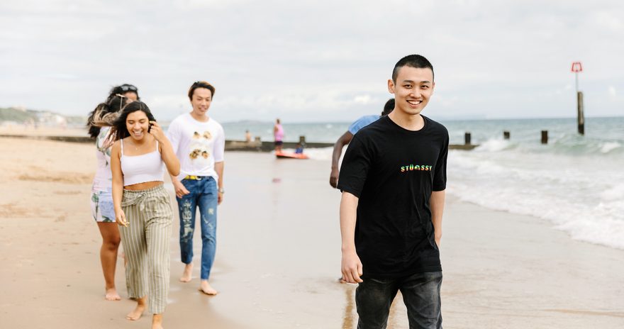 Bournemouth International College students walking on the beach