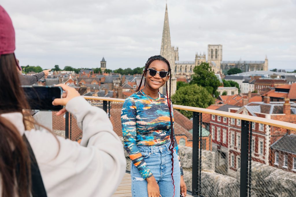 Students taking pictures of each other at the top of Clifford's Tower
