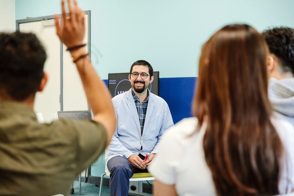 A teacher sitting in front of a classroom