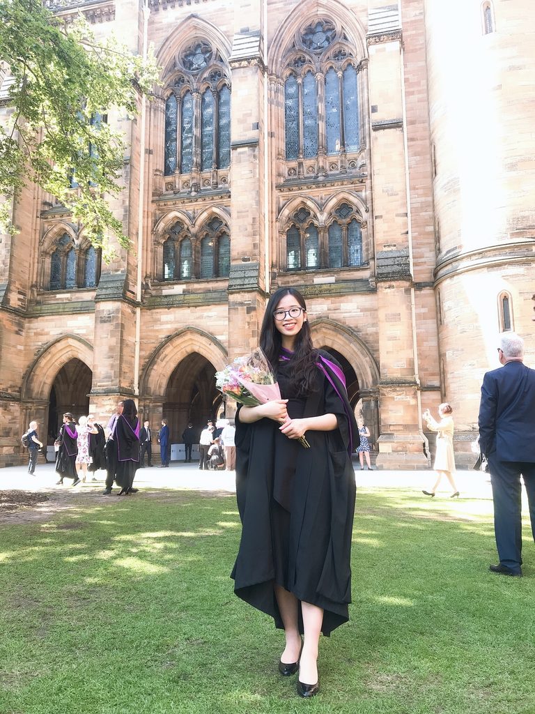 Student from graduation ceremony holding a bouquet