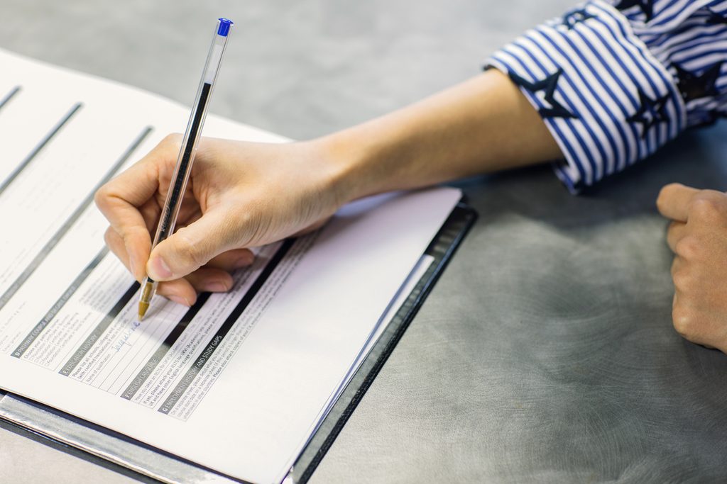 A GIC student filling out a form