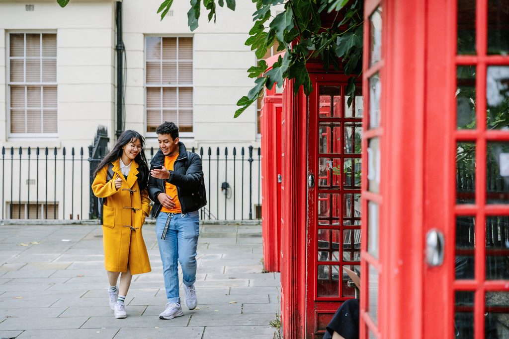 Two KICL students near the classic London phonebooths