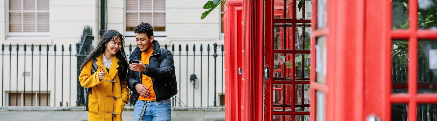 Two KICL students near the classic London phonebooths