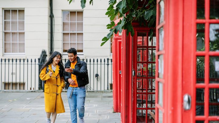 Two KICL students near the classic London phonebooths