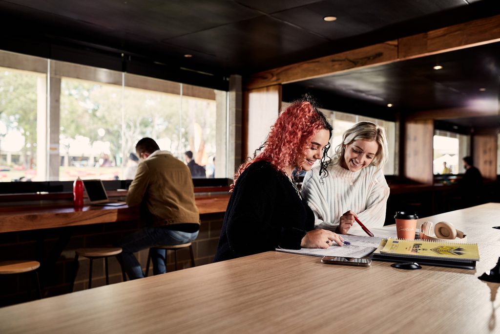 Two Murdoch University students studying in a cafe