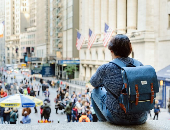 A student overlooking Wall Street in New York