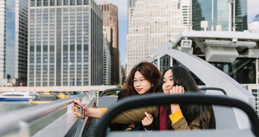 Two students taking a selfie on a boat in New York
