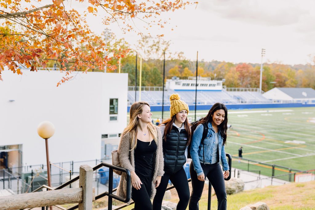 Three students walking in New York near a Pace campus