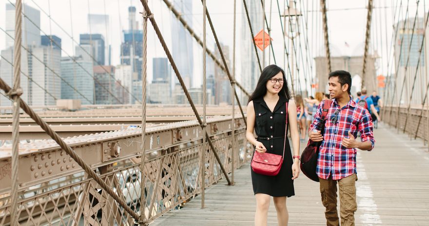 A couple of Pace University students walking on a New York bridge