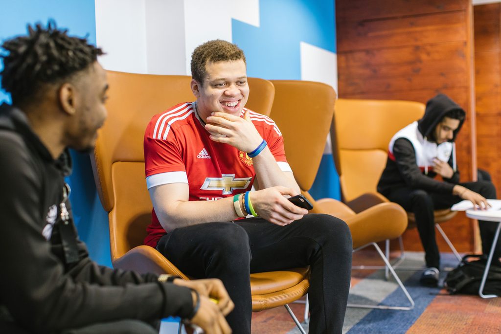 Students sitting next to each other and talking