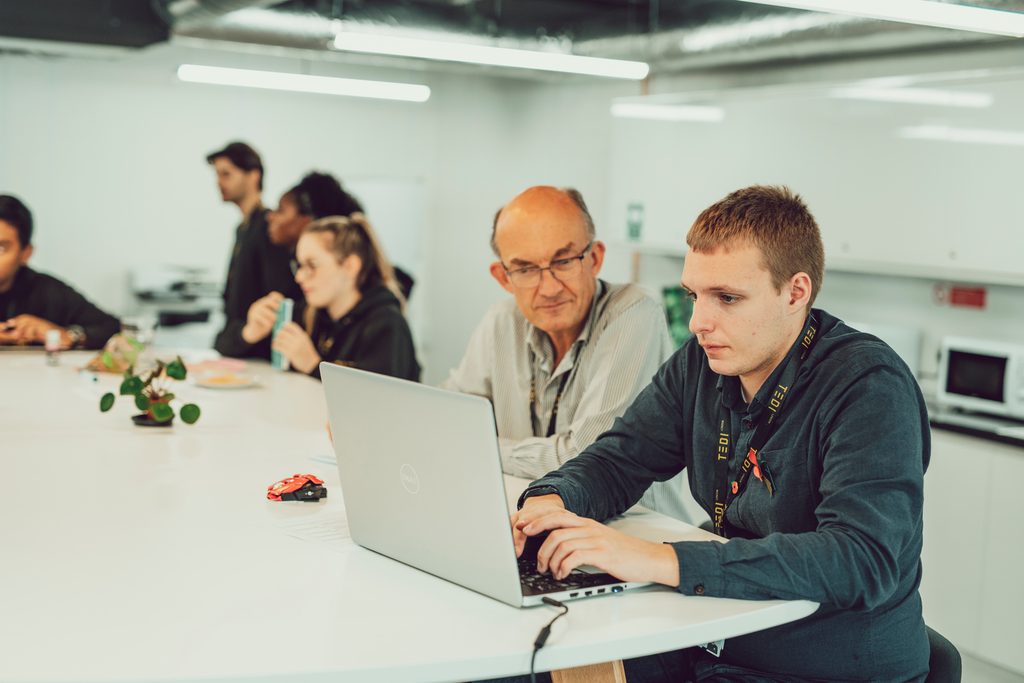 students and teacher working in classroom