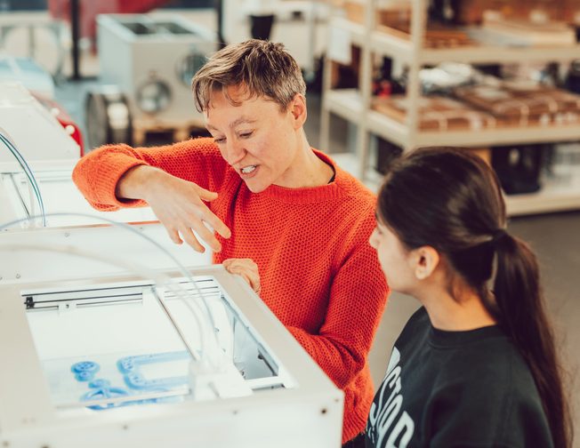 student and teacher using 3D printer at TEDI London