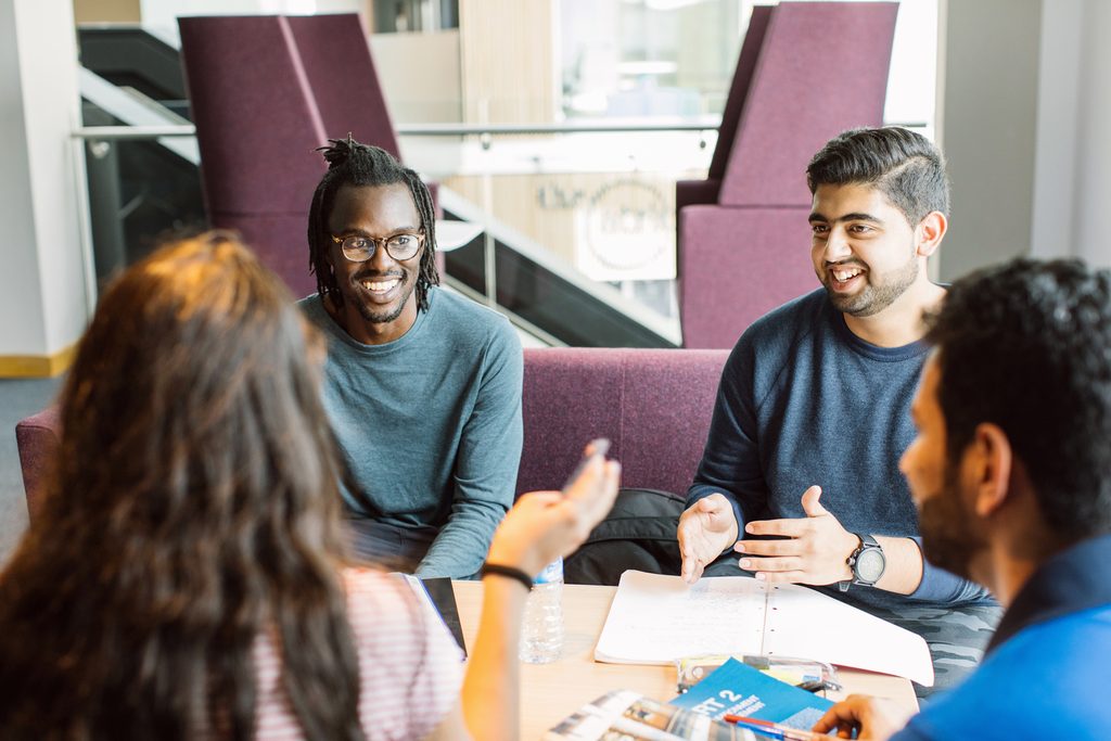 students discussing on sofas on campus