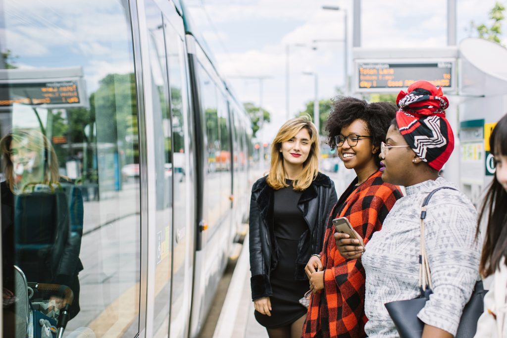 A group of students waiting for getting on tram